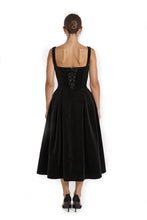 Load image into Gallery viewer, The back view of an elegant black velvet midi dress featuring a structured bodice and corset back with lace detailing on the bust, and a pleated full volume skirt for an hourglass silhouette. Ideal for special occasions like Valentine’s Day, birthdays, date nights, black-tie events, or upscale evening wear.