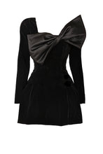 Load image into Gallery viewer, Elegant black velvet mini dress with an oversized satin bow neckline, structured pleated skirt for added volume, and luxurious detailing. Ideal for formal events, Valentine’s Day, Birthdays, cocktail parties, and evening occasions.