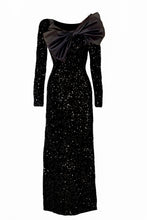 Load image into Gallery viewer, Black sequinned velvet gown. Full length bodycon with a satin bow perfect for red carpet events and black tie soirees.
