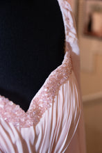 Load image into Gallery viewer, Close-up of a dress with pink beaded trim and pink pleated fabric.
